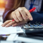 Hands of bank officer calculating loans