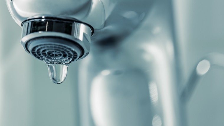 Tap with dripping waterdrop. Water leaking, saving.