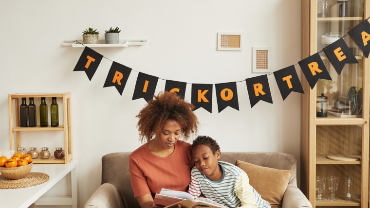 mom and kid reading halloween at home