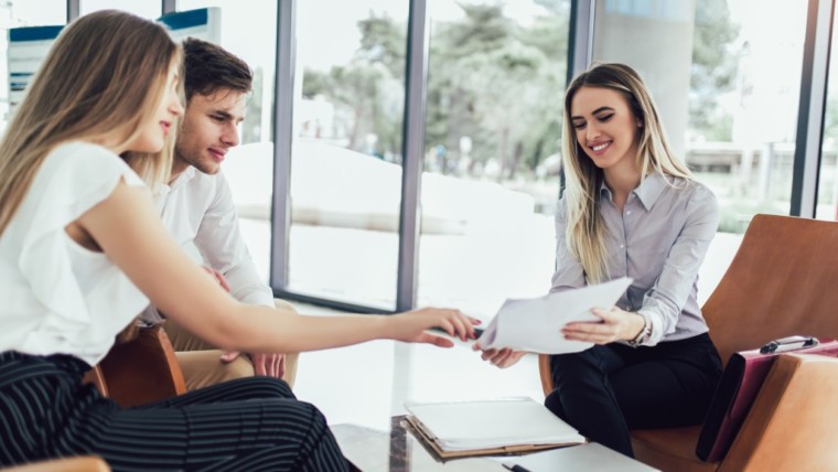 couple discussing rent to own contract with lawyer