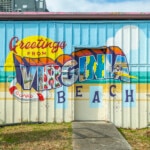 A painted mural that reads "Greetings from Virginia Beach."