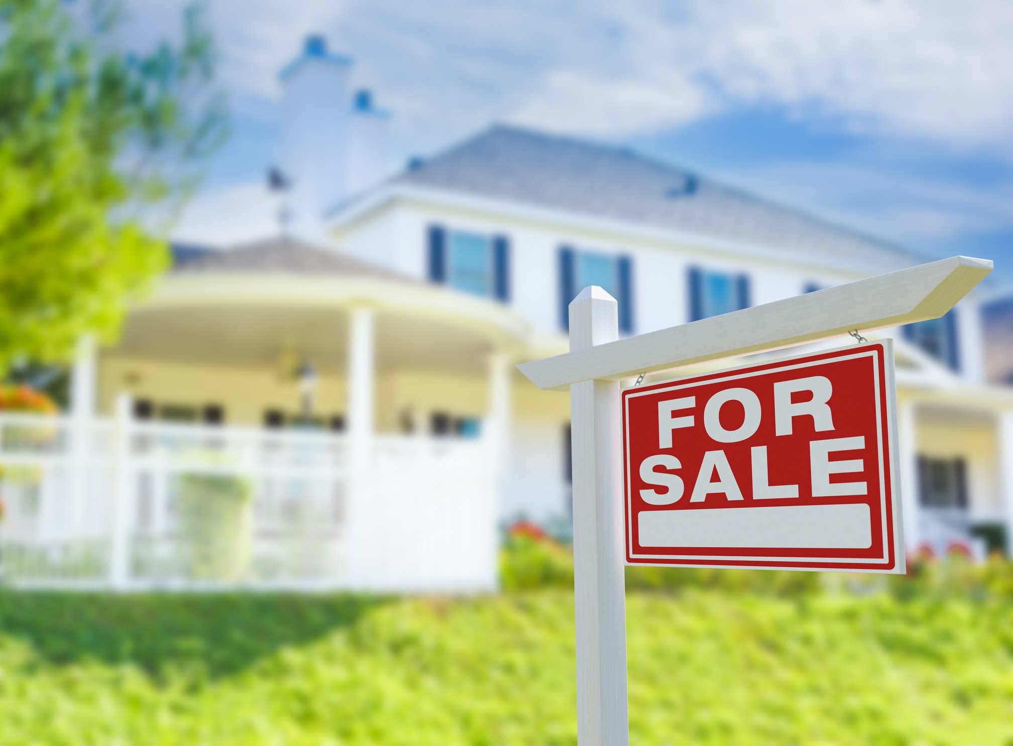 For Sale Real Estate Sign in Front of New House.
