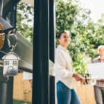 Couple celebrating moving day, mortgage, and relocation concept.